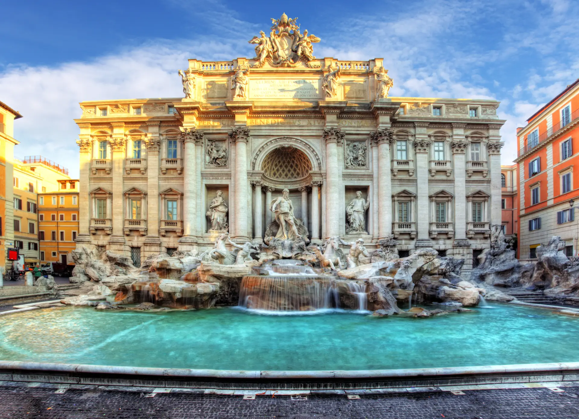 The Trevi Fountain in Rome with bright morning light and turquoise water
